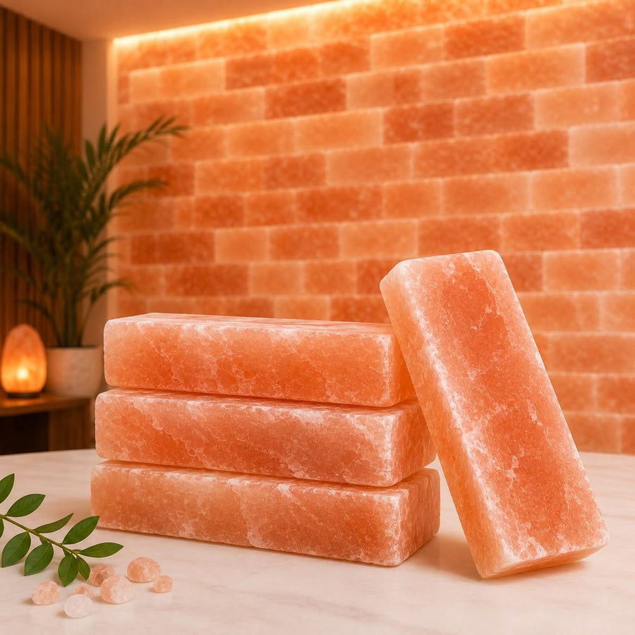 Stacked Himalayan pink salt tiles in front of an illuminated salt-brick wall